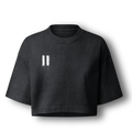 A black cropped short-sleeve t-shirt with a white distressed graphic on the left chest, displayed against a clean white background.