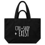 A black canvas tote bag with white printed text reading 'CTRL + SHOP + EXIST' on the front, 