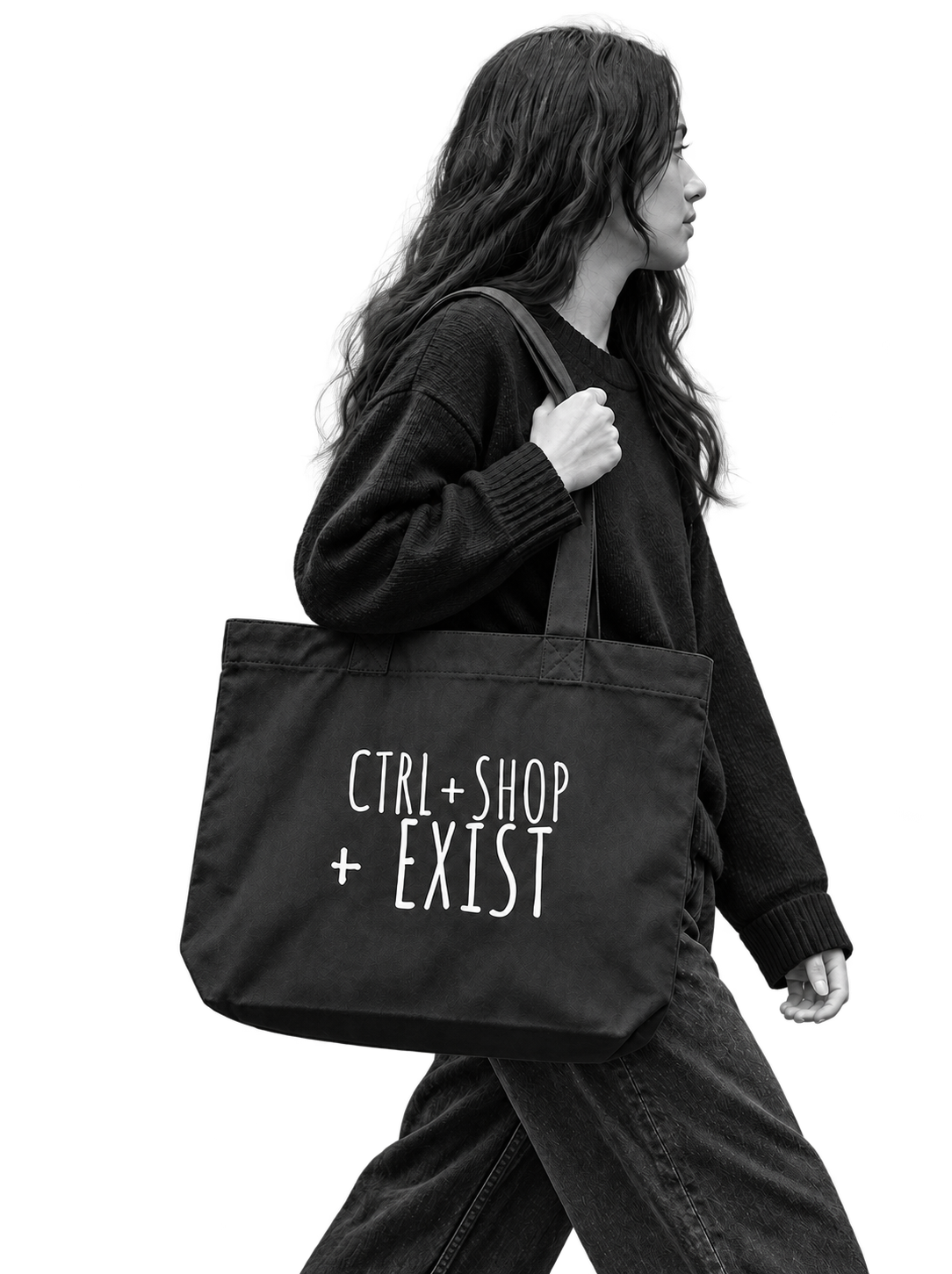 A woman in a black sweater and jeans carries a large black tote bag with the white text 'CTRL + SHOP + EXIST' on the front,model walk