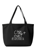 Black tote bag with white text on a dark background