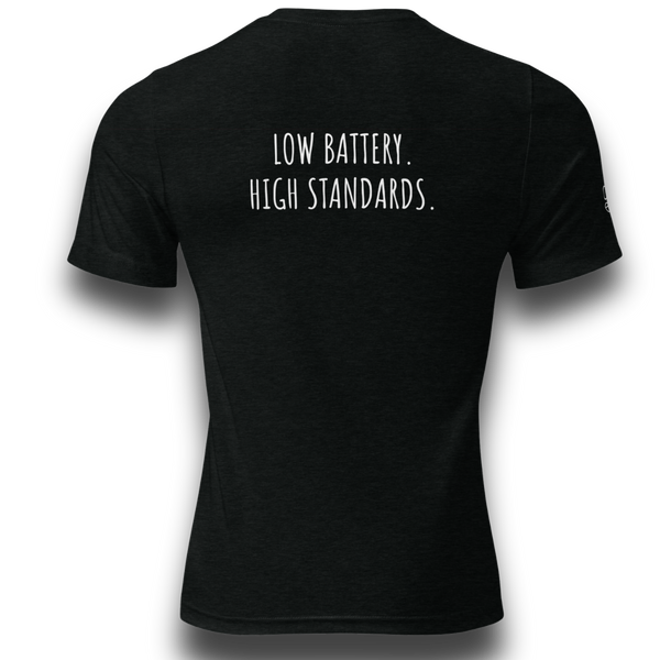 Black tri-blend t-shirt with a minimalist text design. Front reads “TOO AWARE TO ENGAGE.” and back reads “LOW BATTERY. HIGH STANDARDS.”